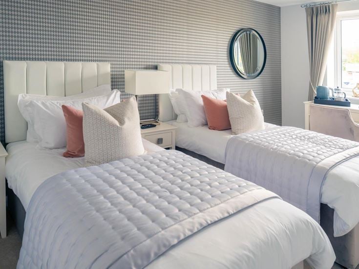 a couple of beds in a hotel room