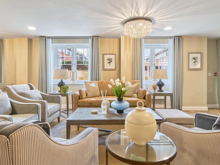 a living room with a large chandelier and a large glass table