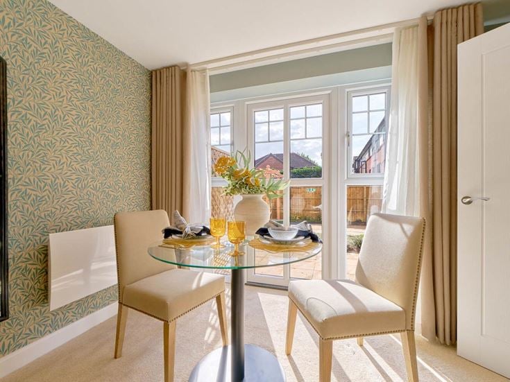 a dining room with a table and chairs
