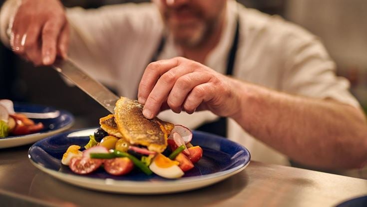 Chef plating up a fish dish