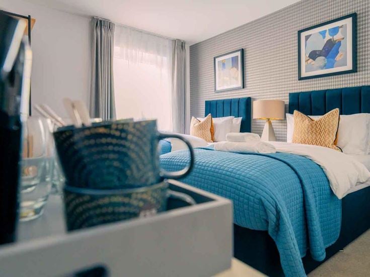 a bedroom with a bed and a mirror