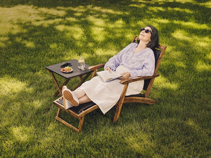 a person sitting in a chair outside