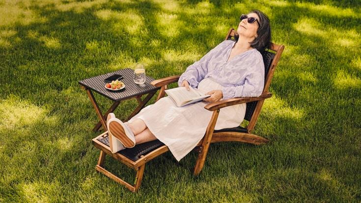 a person sitting in a chair outside