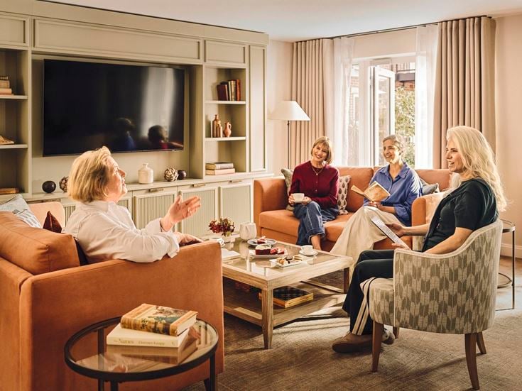 a group of people sitting in a living room