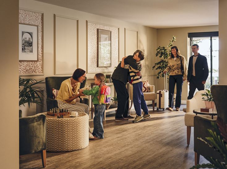 A family visiting their loved ones in a McCarthy & Stone retirement development.