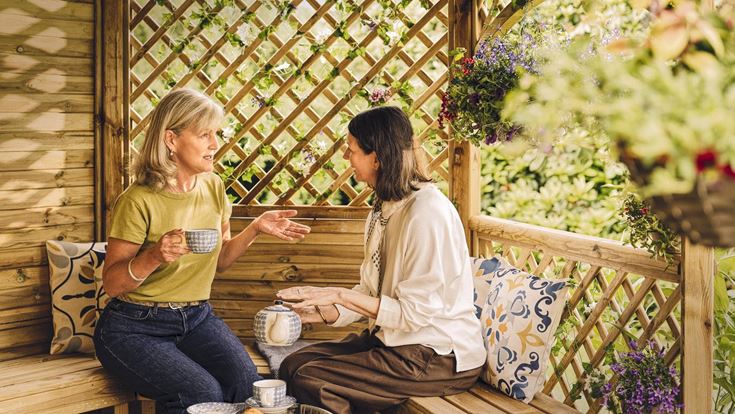 a couple of women sitting on a bench