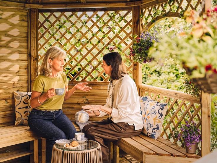 a couple of women sitting on a bench