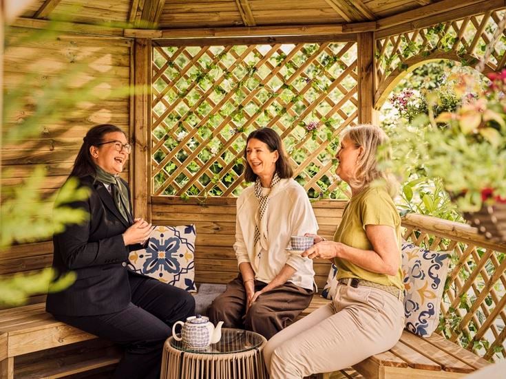 a group of women sitting on a bench