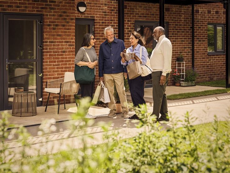 a group of people standing outside a brick building