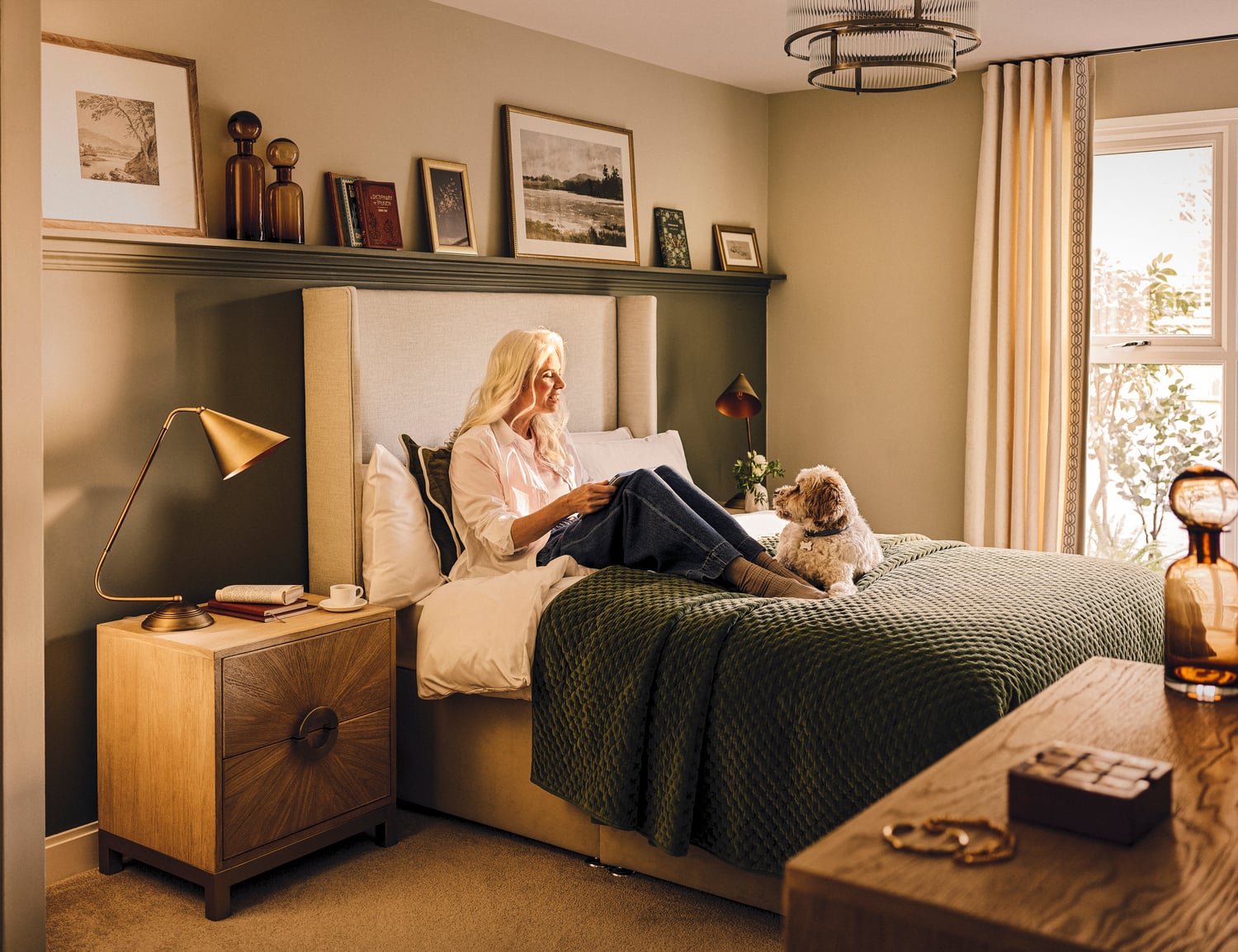a person sitting on a bed with a dog
