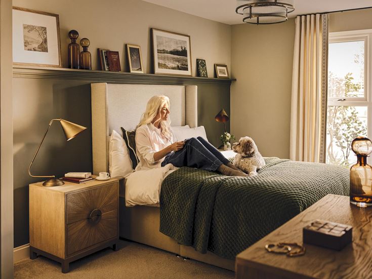 a person sitting on a bed with a dog