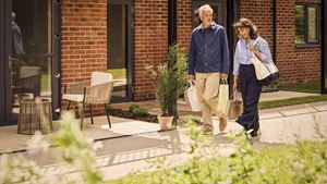 a man and woman walking down a sidewalk