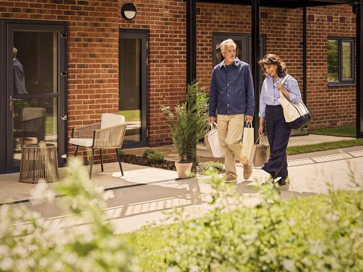 a man and woman walking down a sidewalk