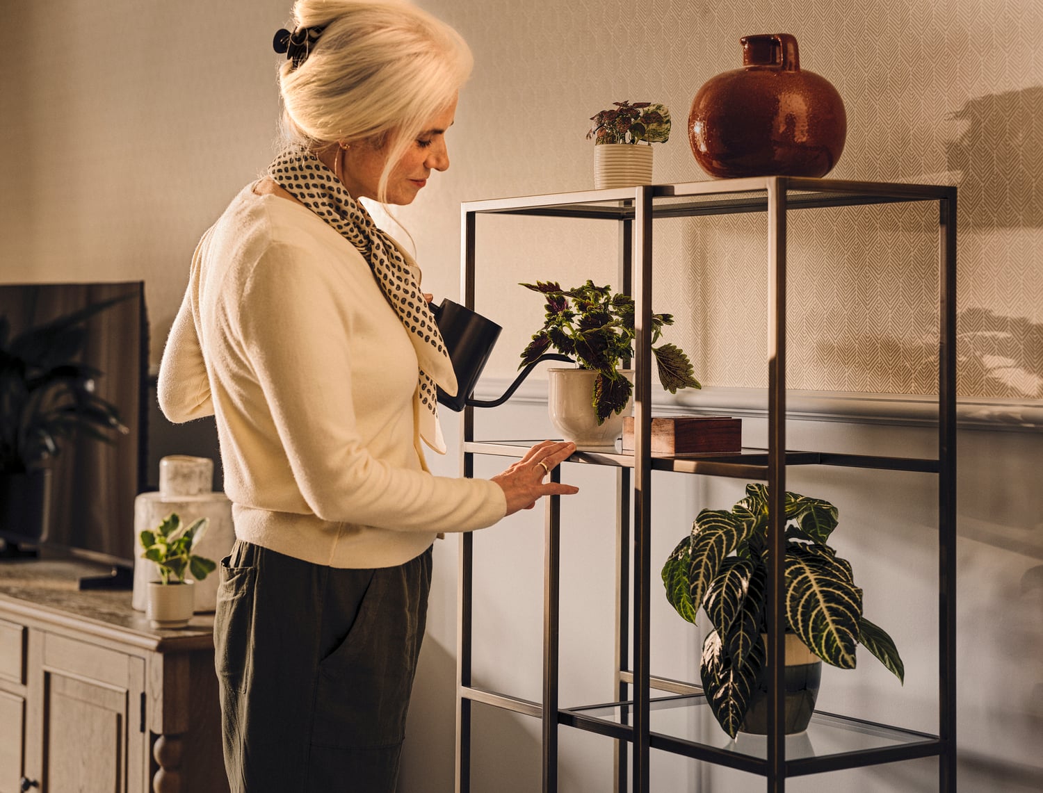 a person looking at a plant