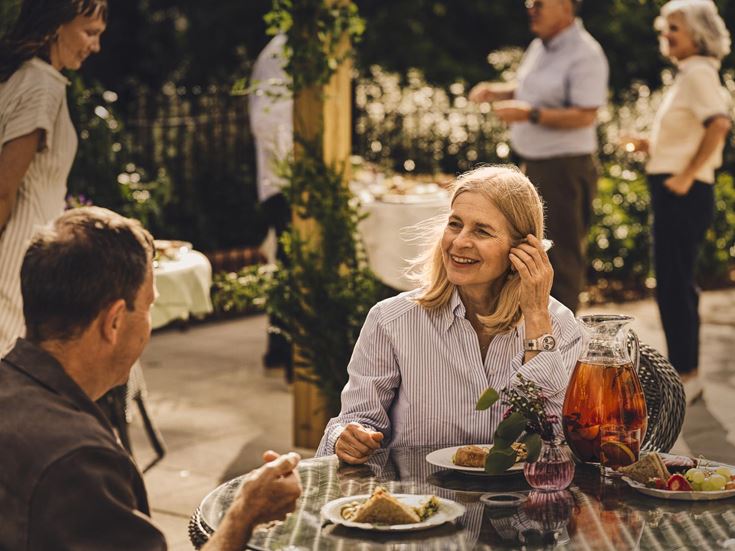a person sitting at a table with food on it