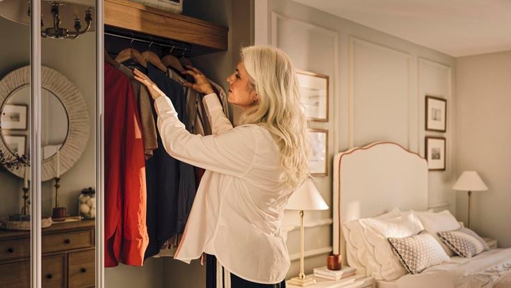 a woman looking at a mirror