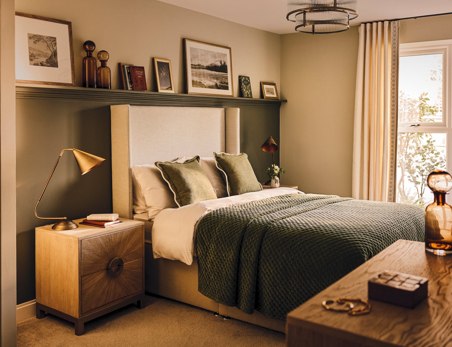 a bedroom with a bed and a shelf with pictures on it