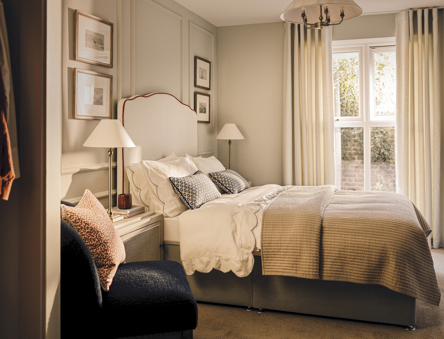 a bedroom with a bed and chairs