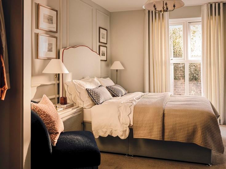 a bedroom with a bed and chairs