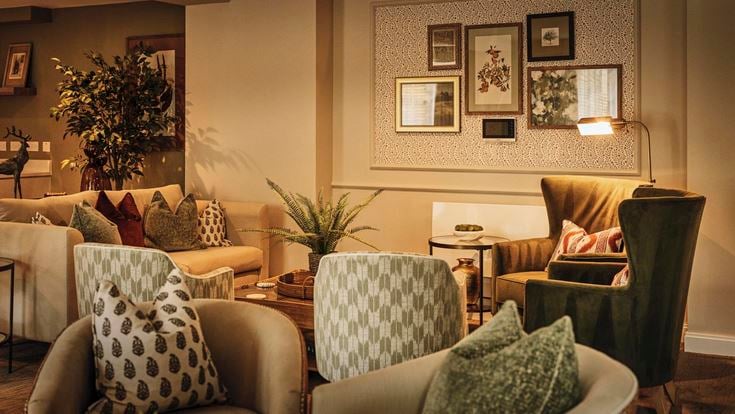 a living room with a couch and chairs