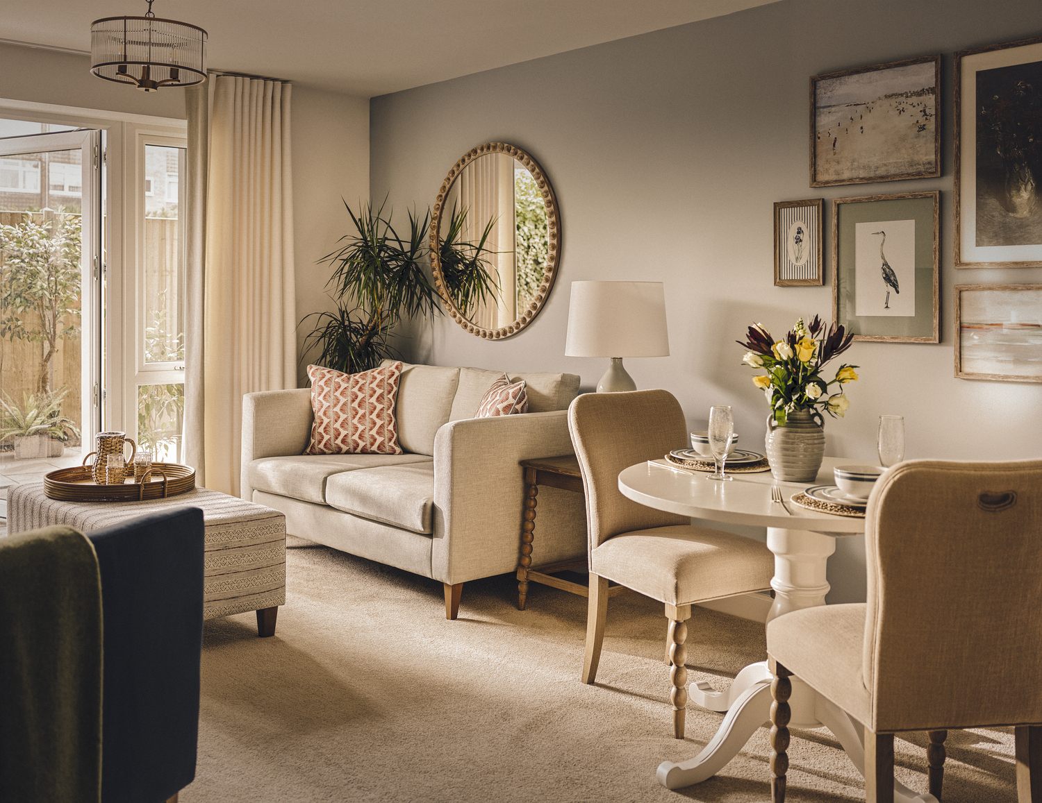 a living room with a round mirror
