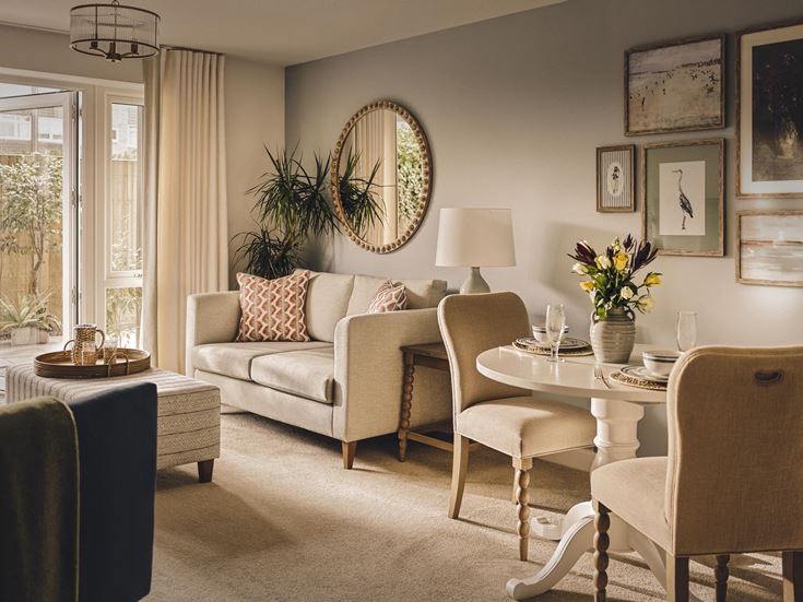 a living room with a round mirror