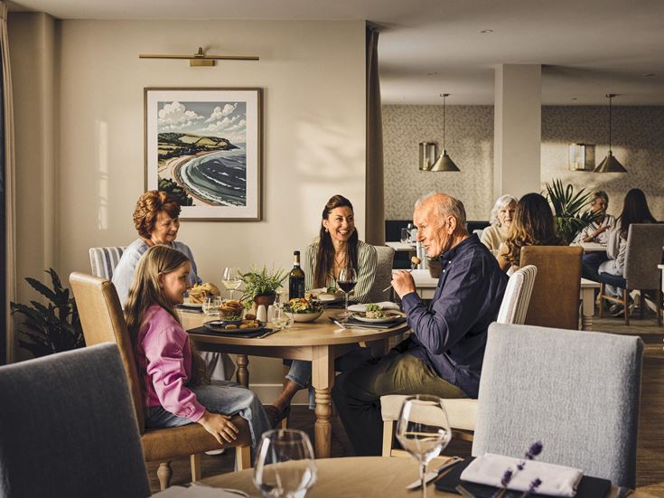 a group of people sitting around a table