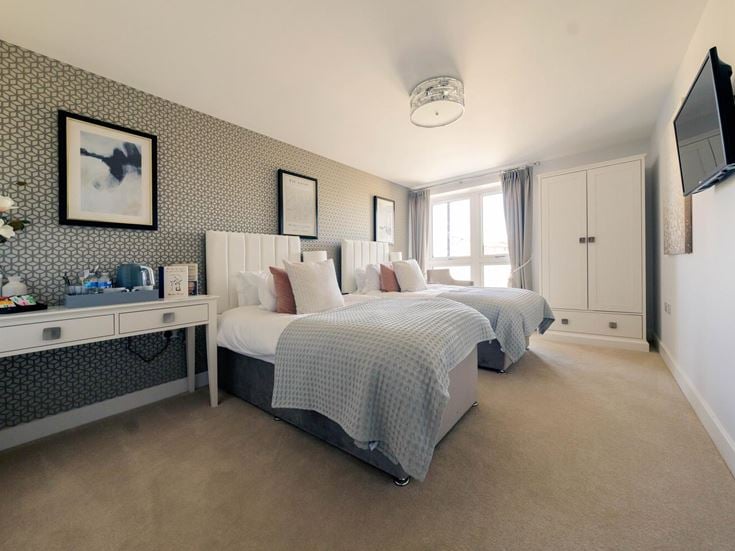 a bedroom with a bed and a tv