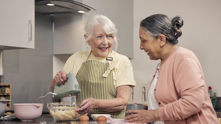 a woman and a man cooking in a kitchen