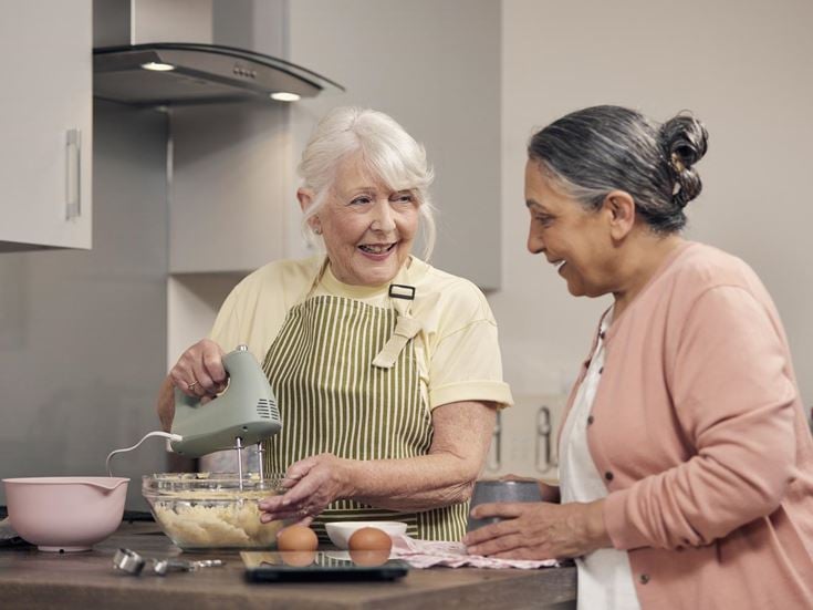 a woman and a man cooking in a kitchen