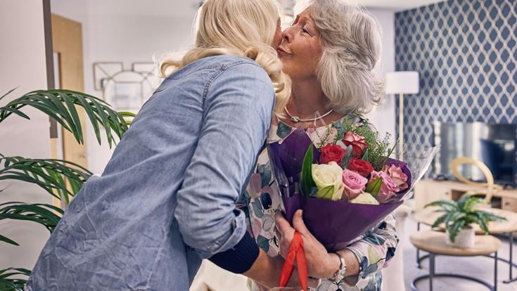 a woman holding a bouquet of flowers
