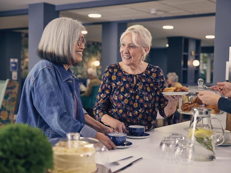 a couple of women eating at a table