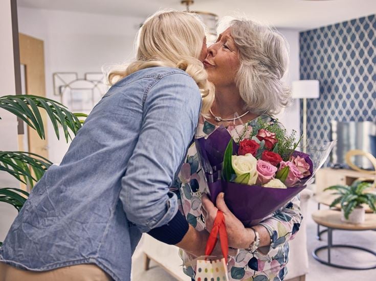 a woman holding a bouquet of flowers