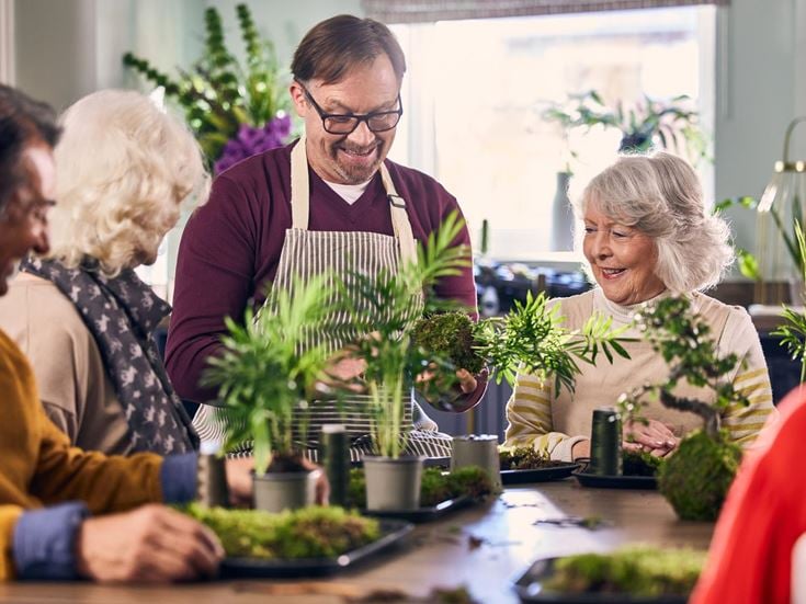 a group of people looking at a plant