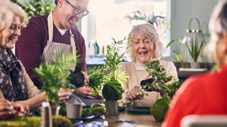 a group of people looking at a plant