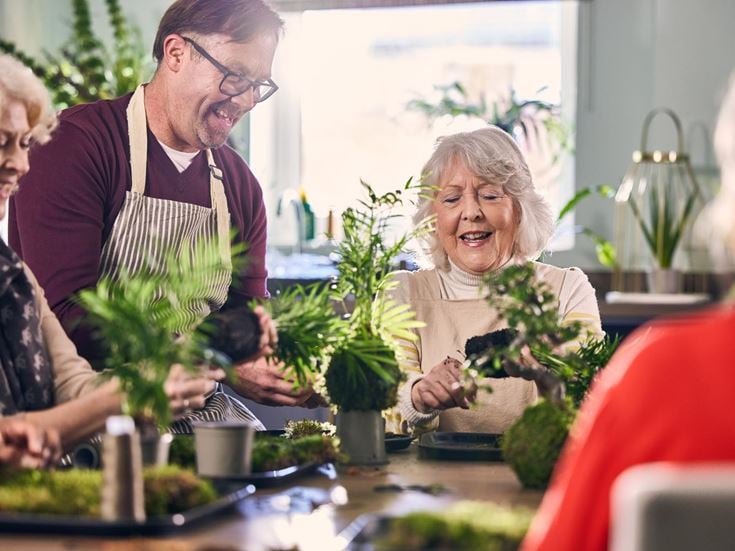a group of people looking at a plant