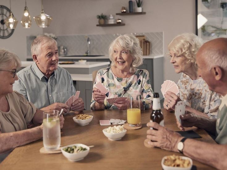 a group of people sitting around a table with food and drinks