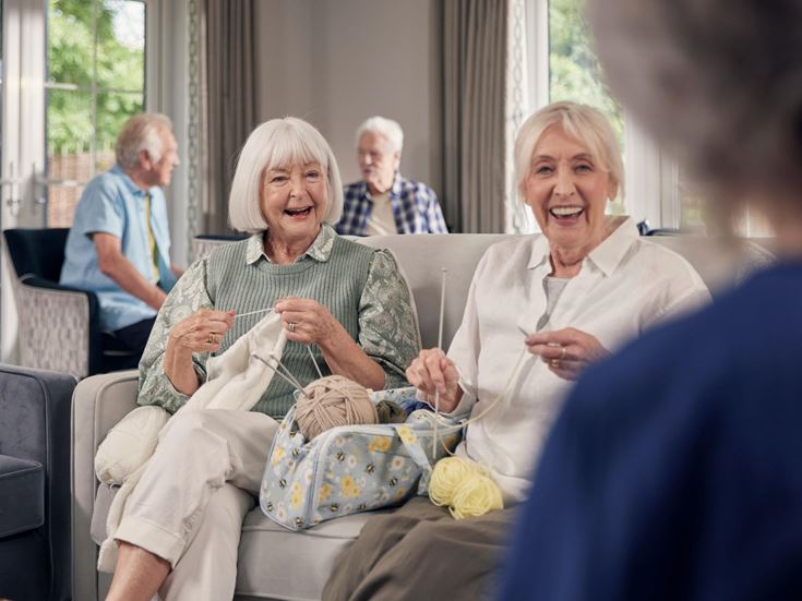 a few elderly people sitting in chairs