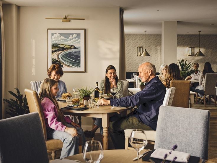 a group of people sitting around a table