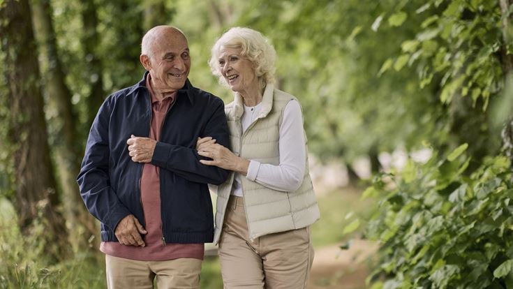 a man and woman standing next to each other and smiling