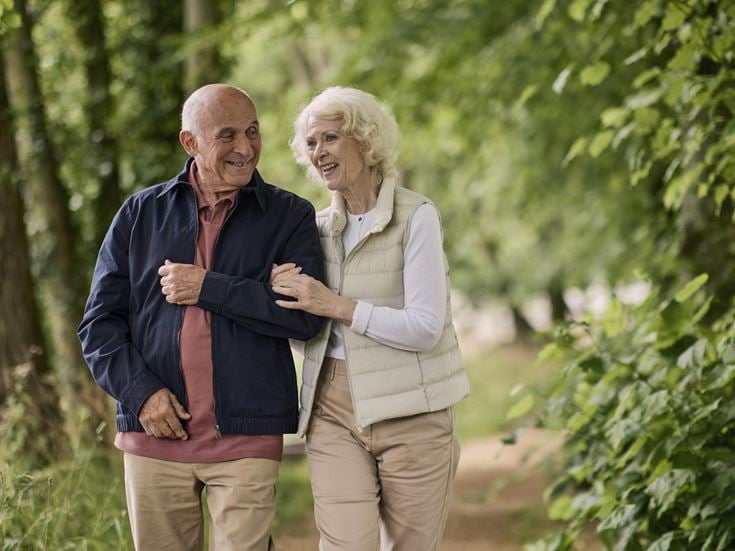 a man and woman standing next to each other and smiling