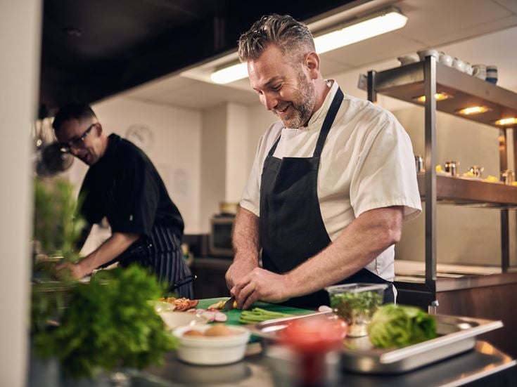 a chef preparing food in a kitchen