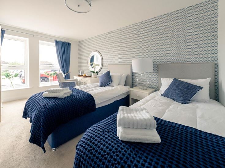 a couple of beds in a room