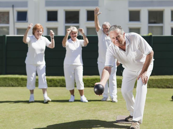 a group of people in white karate uniforms on a field
