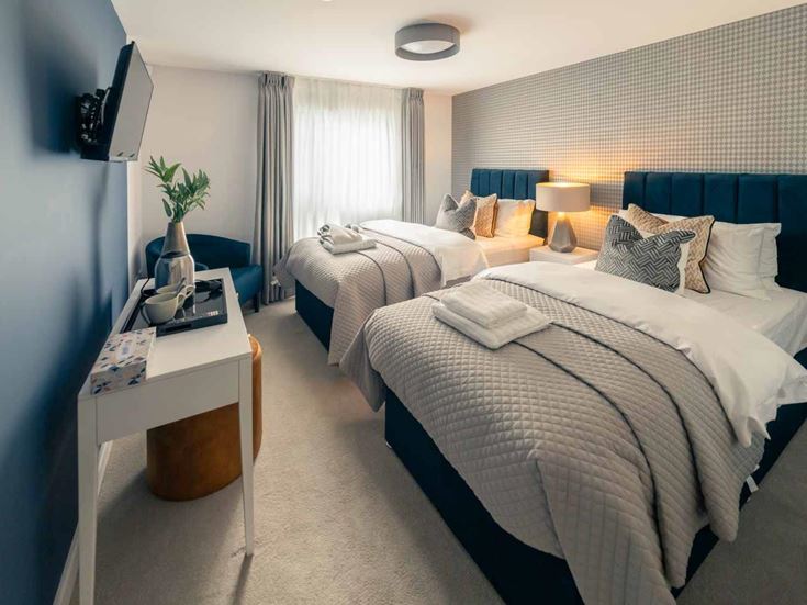 a couple of beds in a hotel room