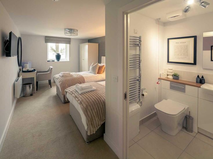 a bathroom with a bed and a sink