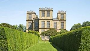 a large building with a green lawn with Hardwick Hall in the background