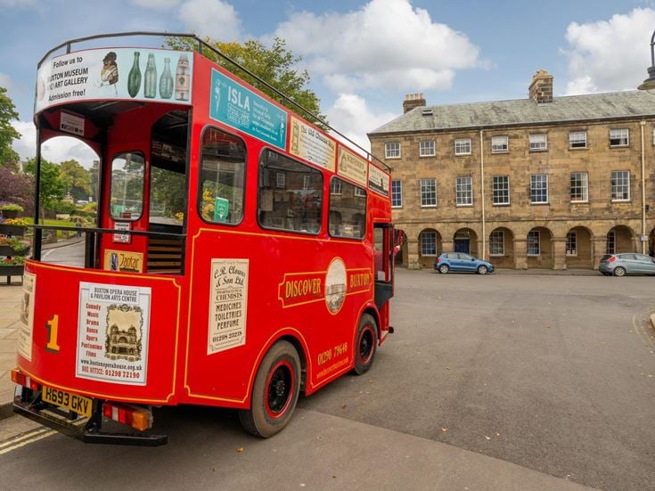 A red bus in Buxton town centre