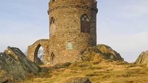 a stone building on a hill