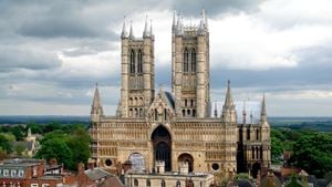 Lincoln Cathedral, with two Gothic towers and a stormy sky.